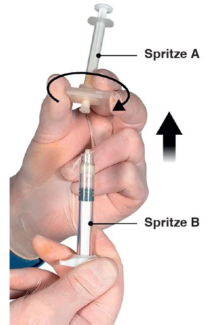 A close-up of a hand holding a syringe

Description automatically generated