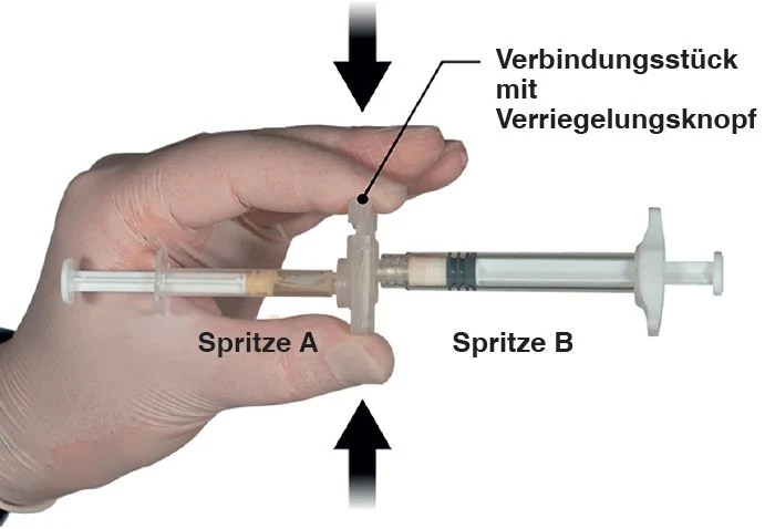 A hand holding a syringe

Description automatically generated